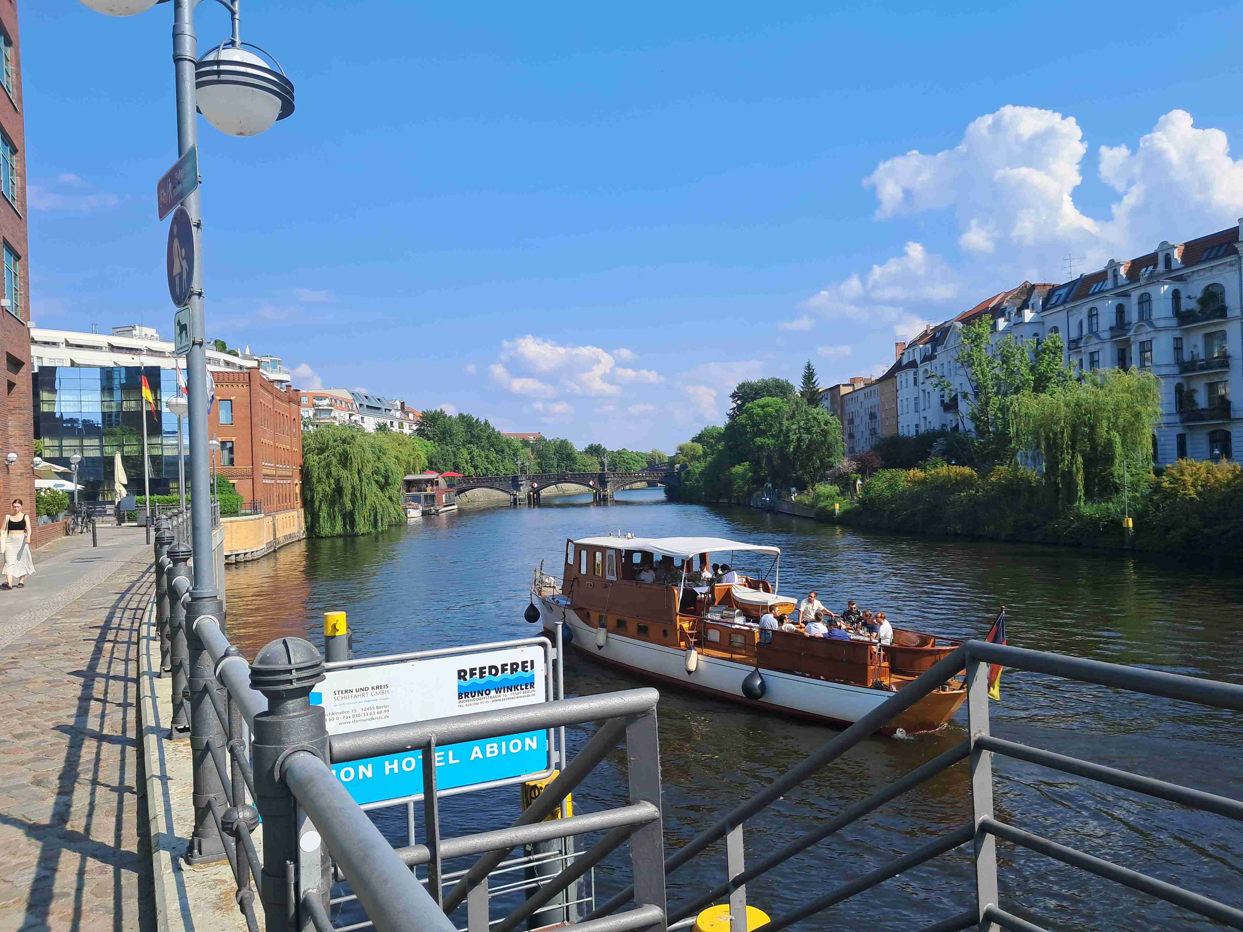 Spree canal. A barge near the pier. Nature on the canal bank.