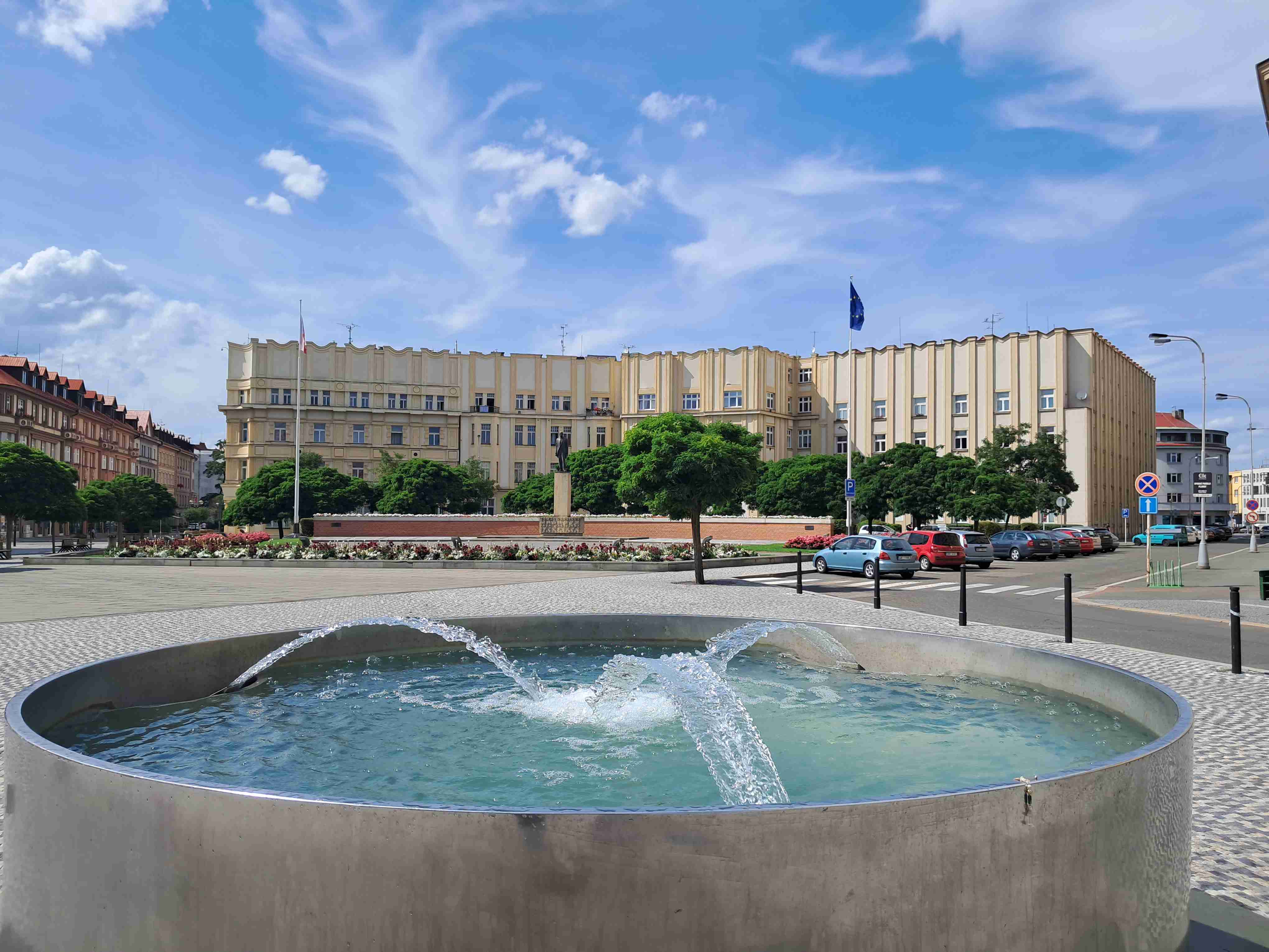 Main Government office building of Hradec Kralove. Fountain and the staute of the first president of Czechia